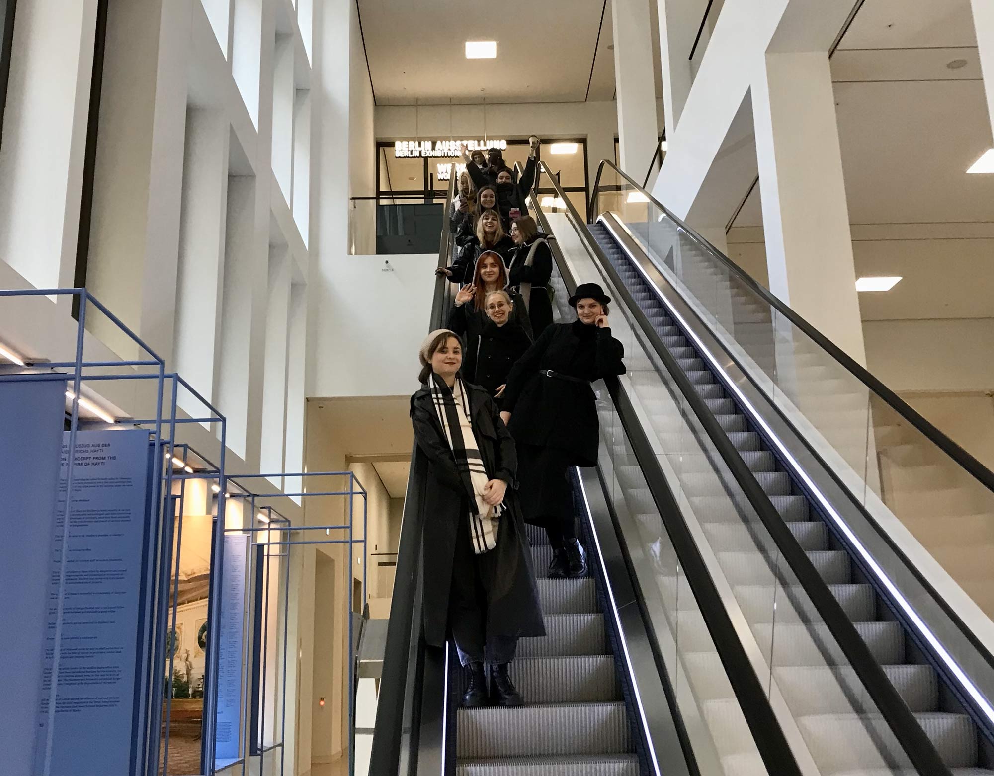 Participants of a study trip to Berlin standing on an escalator.