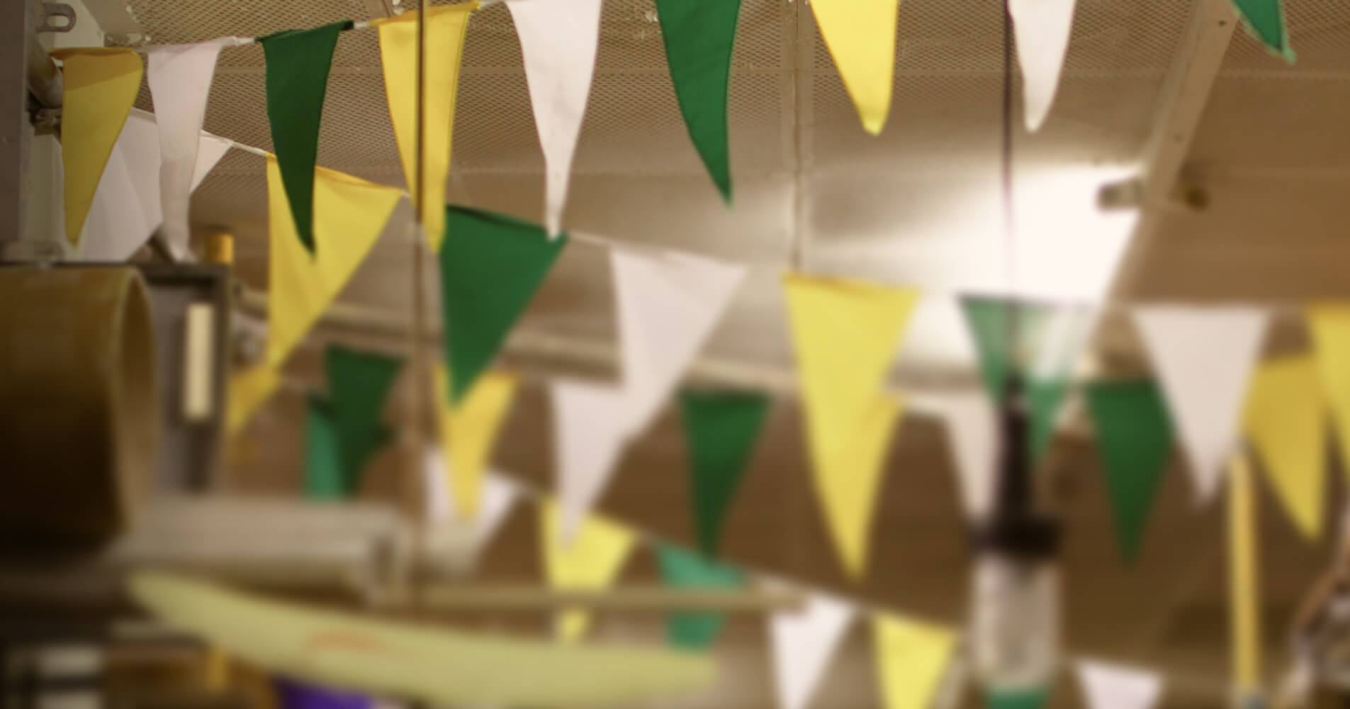 Blurred image of small flags hanging under the ceiling