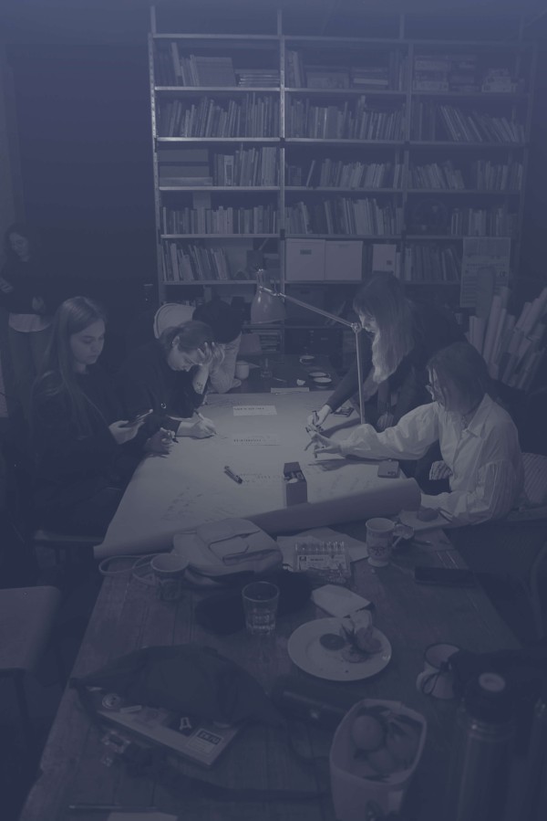 A group of people brainstorming at the table together.